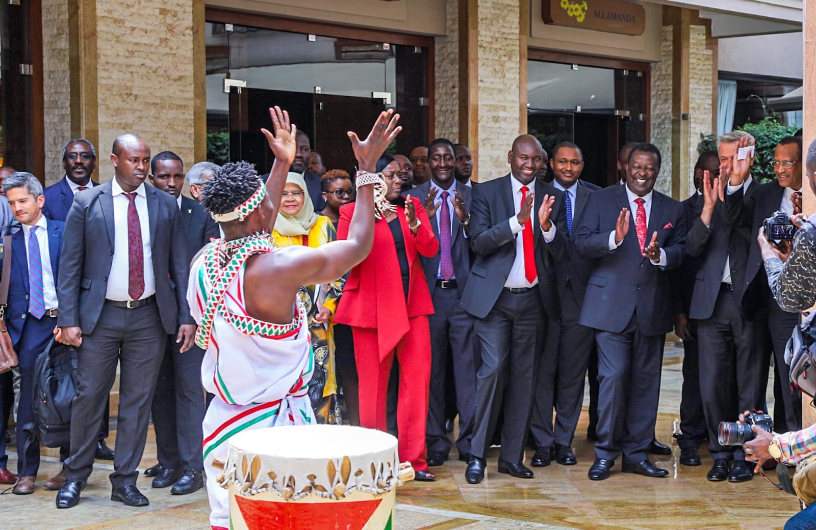 Prime Cabinet Secretary Musalia Mudavadi, UN Commissioner for Refugees Filippo Grandi and Immigration PS Julius Bitok cheer a dancer during the dialogue forum on the integration of refugees in Kenya