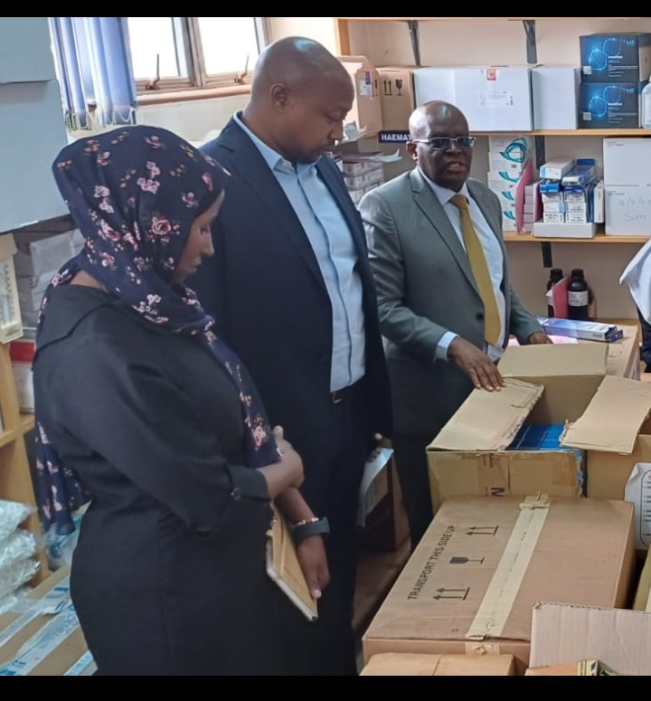 Machakos County Chief Executive Member for health Dr. Daniel Yumbya at far end in a suit as he assesses the Machakos level 5 pharmacy stores.