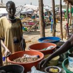 WFP A woman buys food at a market in Bor, South Sudan. (file)