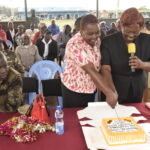 Nyandarua West Deputy County Josephine Kihara (right) and the County Director of Adult Education Margaret Nduku (holding a book) are shown some of the products made by learners at the Githunguchu adult education center.