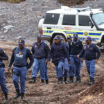 South African police arrest 565 illegal miners.