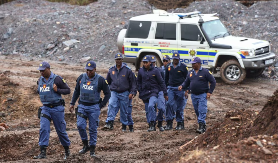 South African police arrest 565 illegal miners.