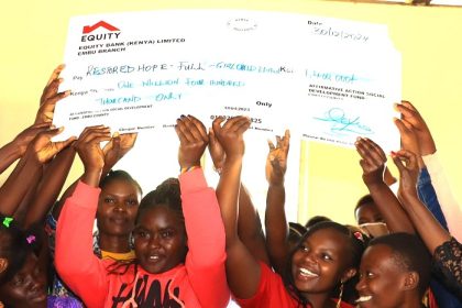 Teen mothers who dropped out of school as a result of pregnancy lifting dummy cheques of their education bursaries. They are set to go back to school as schools reopen in January.