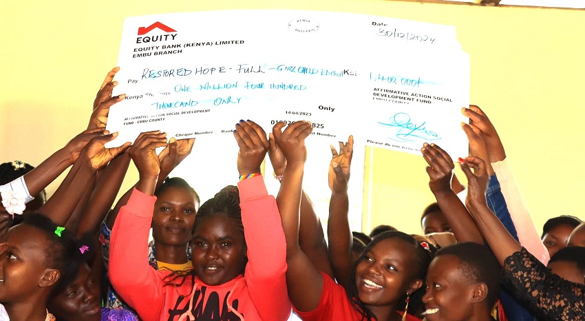 Teen mothers who dropped out of school as a result of pregnancy lifting dummy cheques of their education bursaries. They are set to go back to school as schools reopen in January.